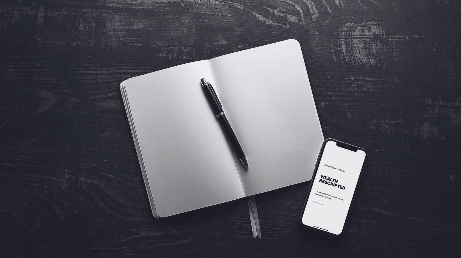 A physical journal and pen positioned next to a smartphone displaying Wealth Rescripted, the first application of The Infinites Protocol.